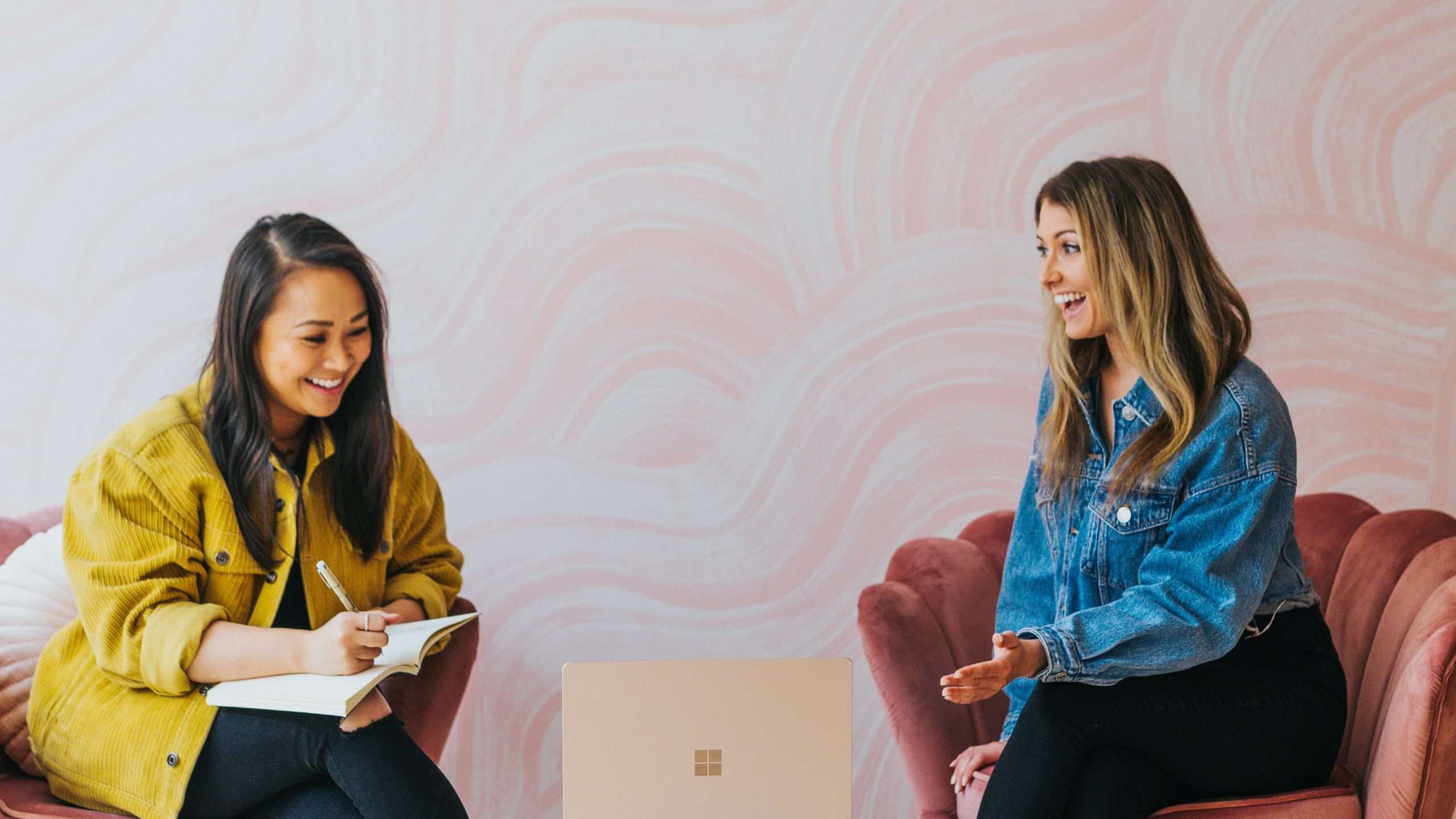 Two female bloggers discussing website growth and monetization strategy with a laptop during a Journey by Mediavine case study analysis