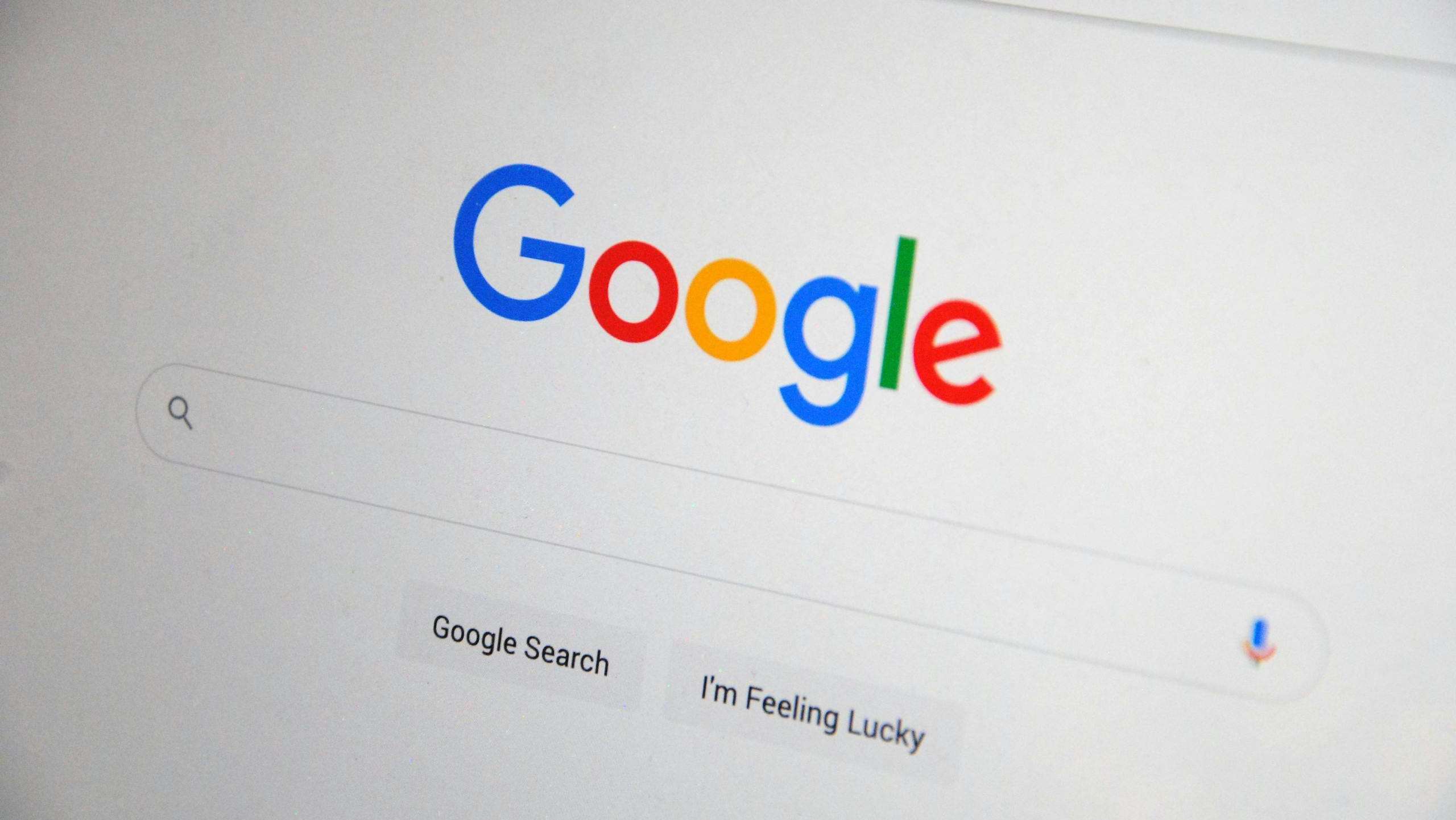 Close-up of the Google homepage on a screen showing search options.